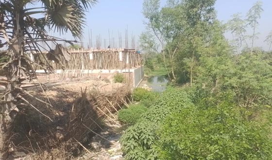সাপাহারে সরকারি খাল দখল করে অবৈধ স্থাপনা নির্মাণ